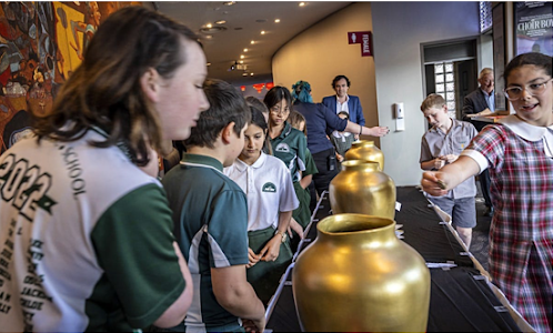Children casting their votes at the golden urns